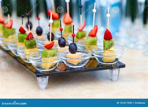 Assorted Canapes Of Fruit And Cheese On A Glass Platter On The ...