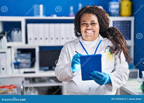 African American Woman Scientist Smiling Confident Writing On Touchpad