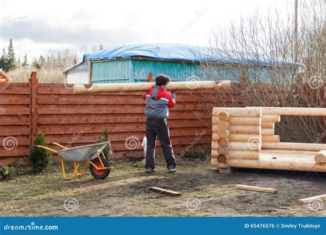 Man Carries Log To Build A Wooden Arbor Stock Photo Image Of Autumn