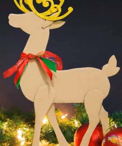 A Wooden Reindeer Ornament Sitting On Top Of A Christmas Tree