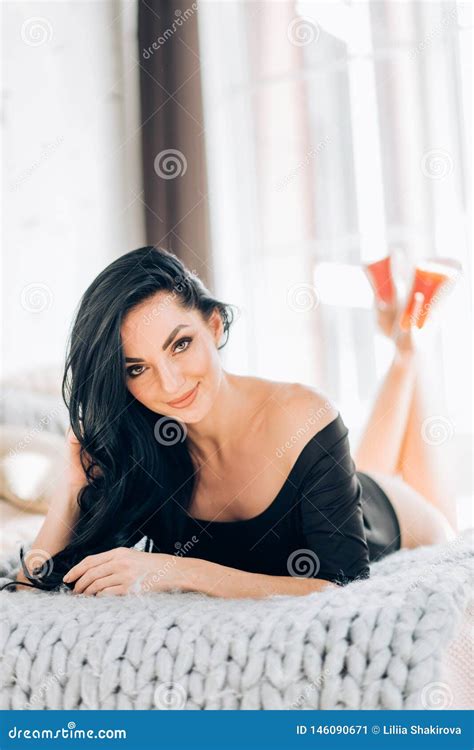 Woman Wearing Stylish Black Lingerie Posing On Bed In Interior Of Luxury Bedroom Stock Image