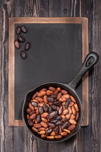 Premium Photo Cocoa Beans In Pan And Chalk Board