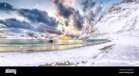 Splendid winter scenery with Haukland beach during sunset and snowy mountain peaks near Leknes ...