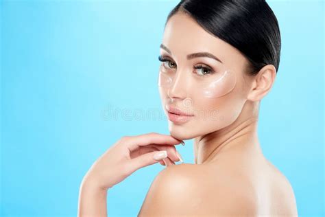 Perfect Girl With Nude Make Up And Naked Shoulders At Studio Background