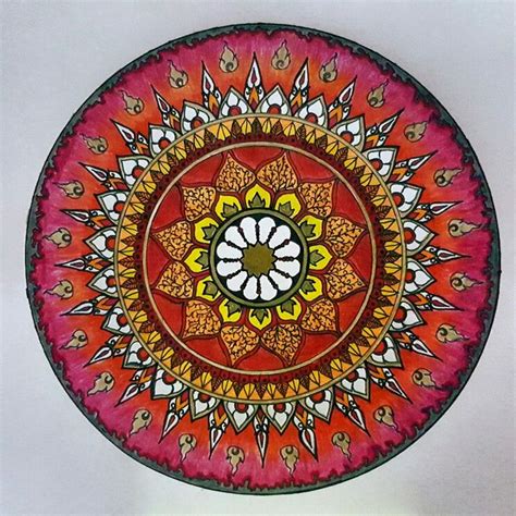 A Red And Yellow Plate With An Intricate Design On The Front Sitting