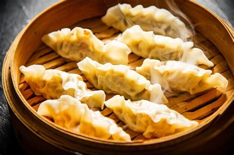 Premium Photo Dumplings Gyoza In A Bamboo Steamer With Hot Steam