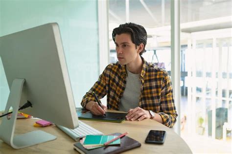 Premium Photo Male Graphic Designer Using Graphic Tablet At Desk