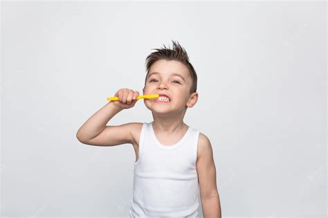 Premium Photo | Little boy brushing teeth