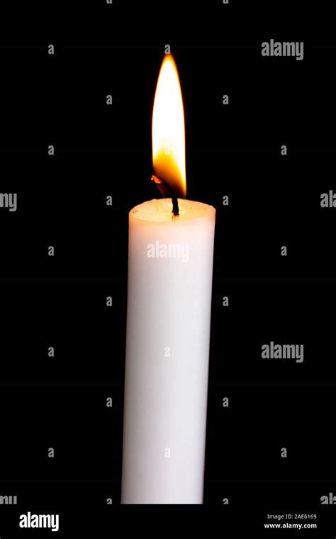 One white burning candle in the dark Stock Photo - Alamy