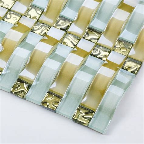 A Close Up Of A Glass Tile With Gold And Blue Designs On The Bottom Half