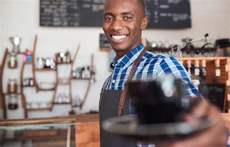 Smiling African Female Warehouse Worker Leaning Against Some Boxes