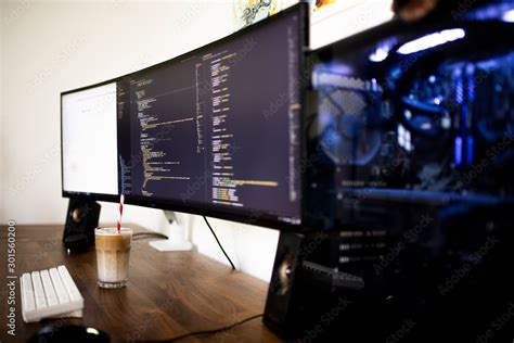programming coding   ultra widescreen monitor screen stock photo