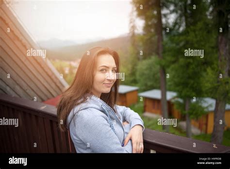 Beautiful Brunette Teen Girl With Long Hair Leaning On Railing Stock