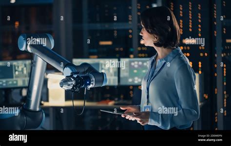 Female Engineer With Tablet Computer Analyse How A Futuristic Robotic