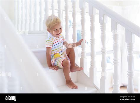 Kid Walking Stairs In White House Baby Boy Playing In Sunny Staircase