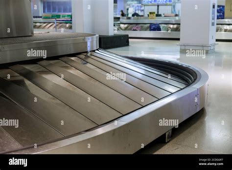 A Rotating Black Rubber Airport Baggage Claim Carousel Conveyor Belt