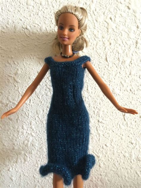 A Barbie Doll Wearing A Blue Knitted Dress