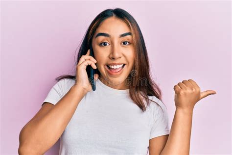 Young Latin Woman Having Conversation Talking On The Smartphone