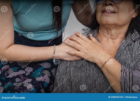 Loving Adult Daughter Hugging Older Mother Standing Behind Couch At