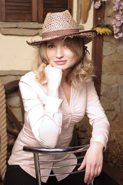 Premium Photo Portrait Of Pretty Woman In Straw Hat On Armchair Look