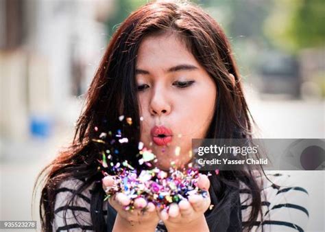 girl blowing glitter stock  high res pictures  images