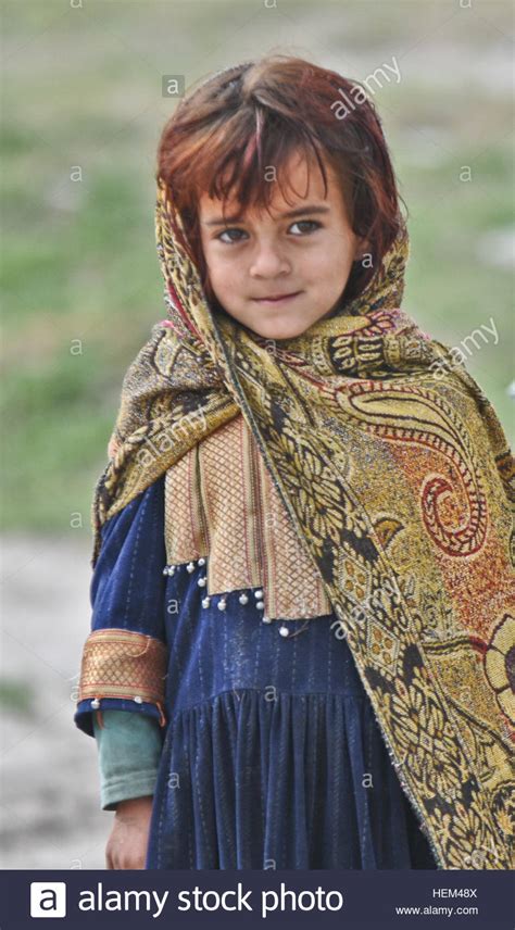 An Afghan Girl Looks On As Paratroopers From 3rd Platoon Apache