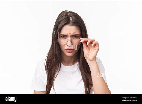 Close Up Portrait Of Suspicious Young Serious Looking Woman Look From