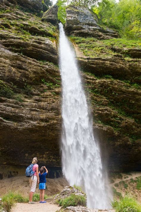 Active Tourists Looking At Pericnik Waterfall In Vrata Valley In