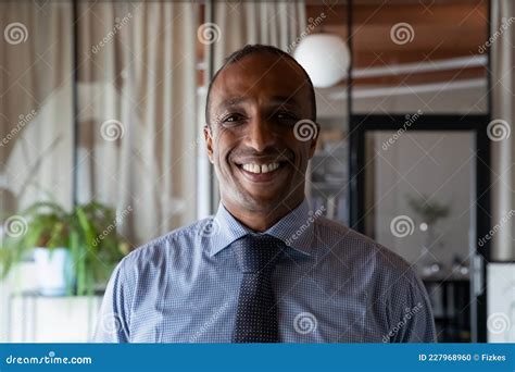 Headshot Portrait Of Smiling African American Businessman At Workplace