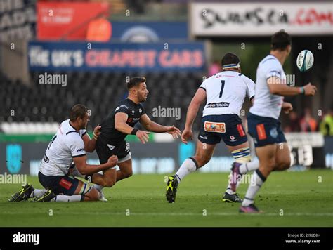 Rhys Webb of Ospreys Rugby, gets the ball away under pressure from Walt ...