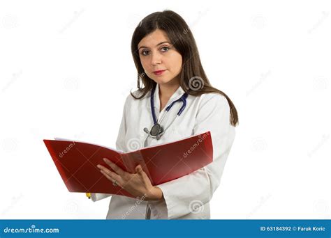 Portrait Of Young Confident Female Doctor Holding Folder Stock Photo