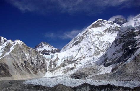 the mountains are covered in snow and clouds