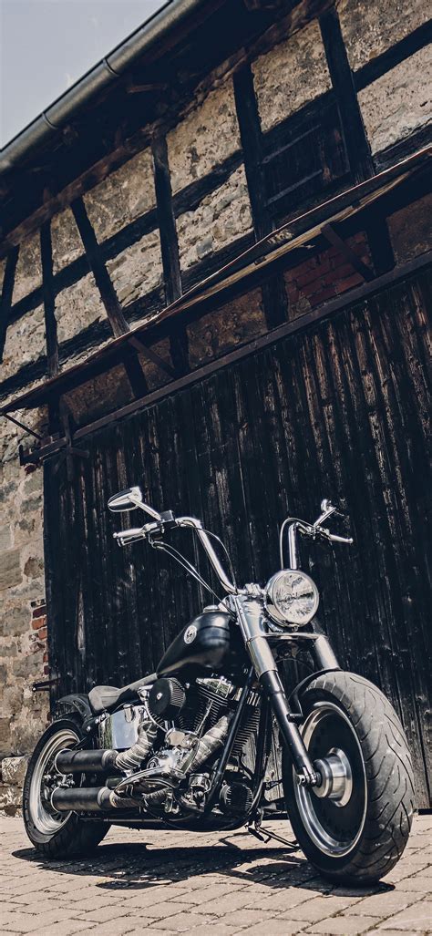 Harley Davidson Motorcycle Parked In Front Of Brick Building