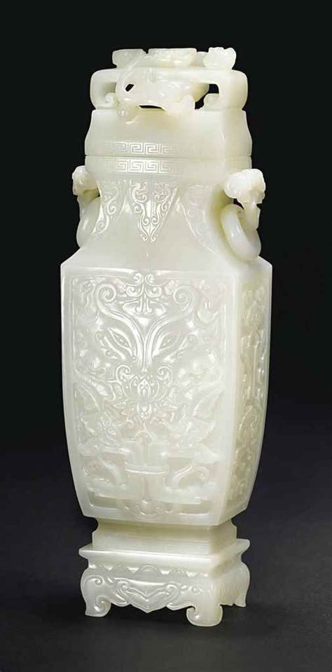 A WHITE JADE ARCHAISTIC VASE COVER AND STAND 白玉雕仿古饕餮紋連座蓋瓶 10 ¼ in 26