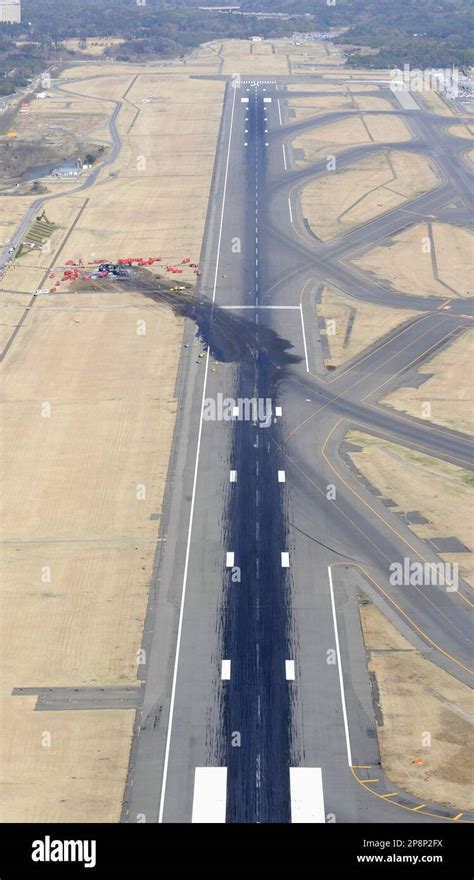 A Burnt Fedex Cargo Plane Is Seen On The Ground Off A Runway After It