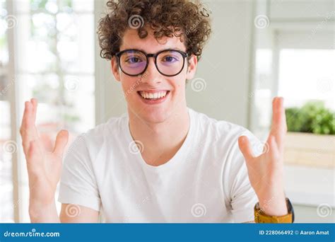 Young Handsome Man Wearing Glasses Celebrating Crazy And Amazed For