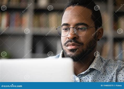 Close Up Serious African American Man Looking At Computer Screen Stock