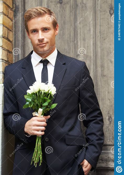 Dream Guy Portrait Of A Handsome Man Smiling And Holding A Bunch Of