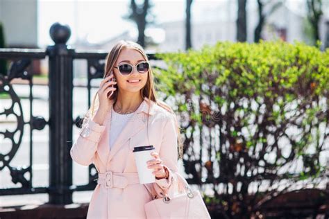 Upper Class Woman Fashionable Woman Texting Outdoors Fashion Woman In A Sunglasses And Pink