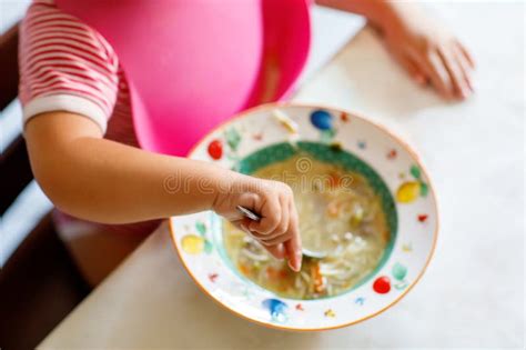 Adorable Baby Girl Eating From Spoon Vegetable Noodle Soup Healthy