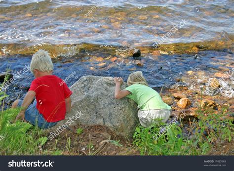 Young Kids Throwing Rocks At The Lake Stock Photo 11063563 : Shutterstock