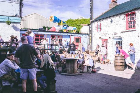 People Enjoying a Sunny Day in the Pubs in Dingle, Small Port Town on the Southwest of Ireland ...