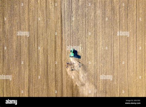 Aerial View Of A Tractor Plowing Black Agriculture Farm Field After