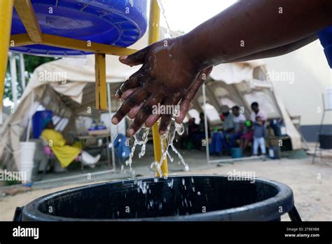 A Woman Washes Her Hands Before Entering A Tent With Cholera Patients