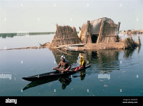 Marsh Arabs Southern Iraq. Marsh Arab man with daughter in boats with ...