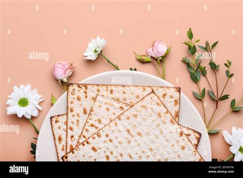 Plate With Jewish Flatbread Matza For Passover And Flowers On Color