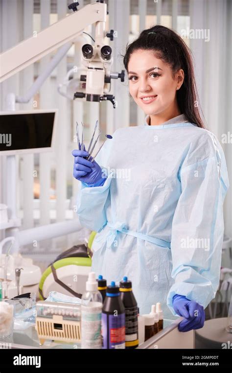 Portrait Of A Pretty Woman Dentist Wearing Doctors Uniform Gloves