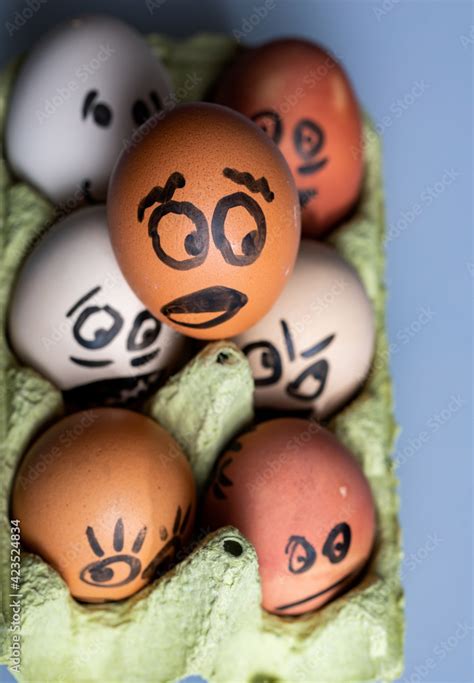 Crazy eggs terrified. Scared faces peering out of the egg tray. Funny ...