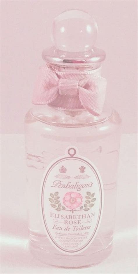 A Bottle Of Perfume With A Pink Bow On It