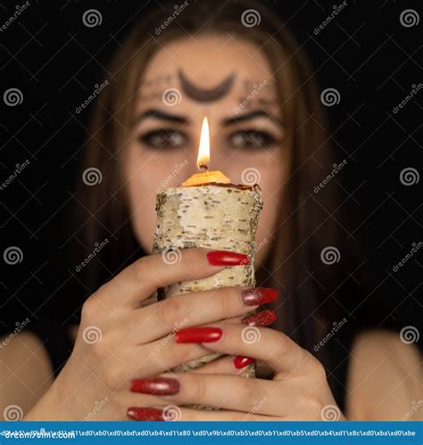 On Halloween The Witch Holds A Burning Candle In Front Of Her Face And